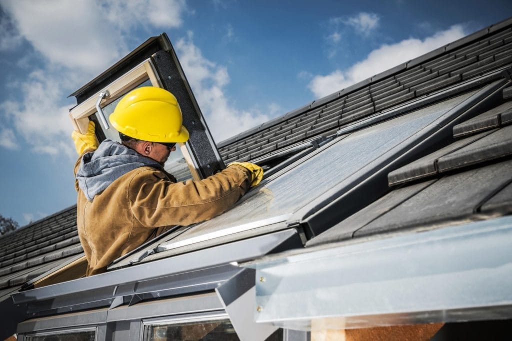 worker-repairing-roof-window-min