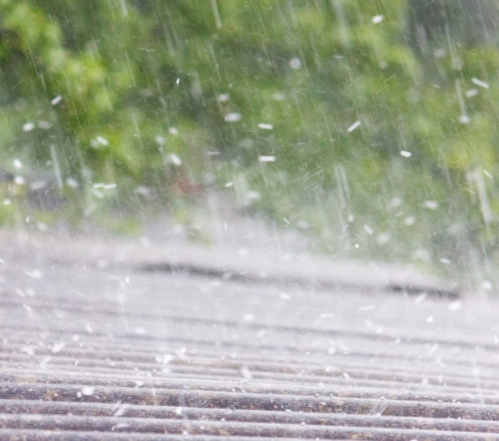 Roof showing signs of hail damage in McKinney with dented shingles and granule loss