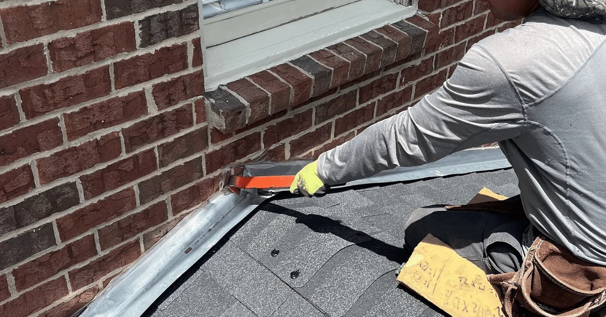 Roof technician repairing flashing to stop water intrusion