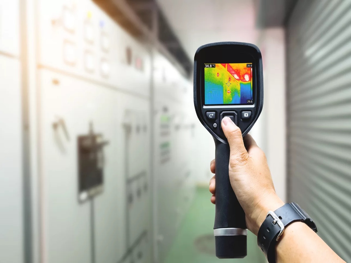 Technician using thermal imaging to detect moisture