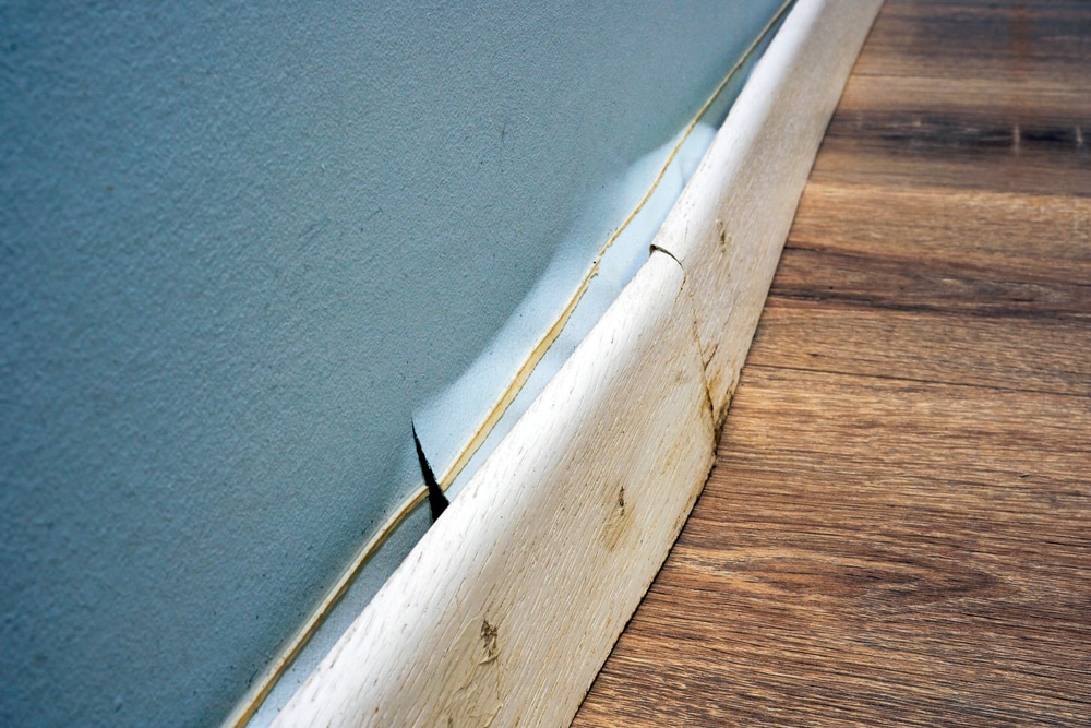 Subtle water staining along baseboards inside a residential home