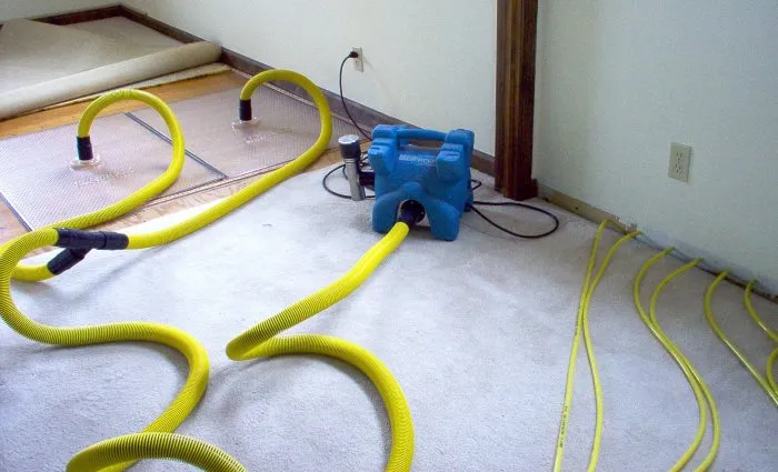 high power industrial water extraction tool on a flooded floor during water mitigation