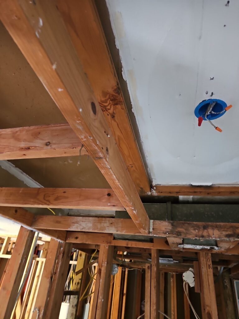 Exposed ceiling framing and removed drywall during water mitigation in a Dallas, TX interior