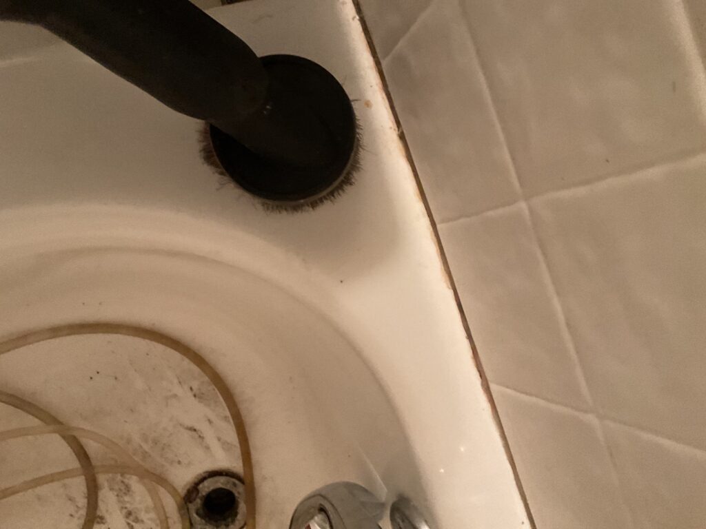 Bathtub drain and plumbing area inspected during bathroom water mitigation in Plano, TX