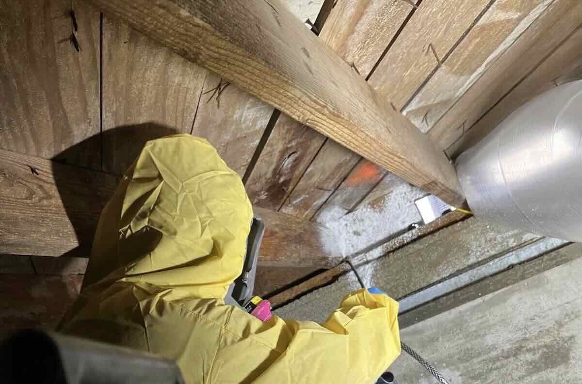 Rainy Day technician performing crawl-space moisture-control work