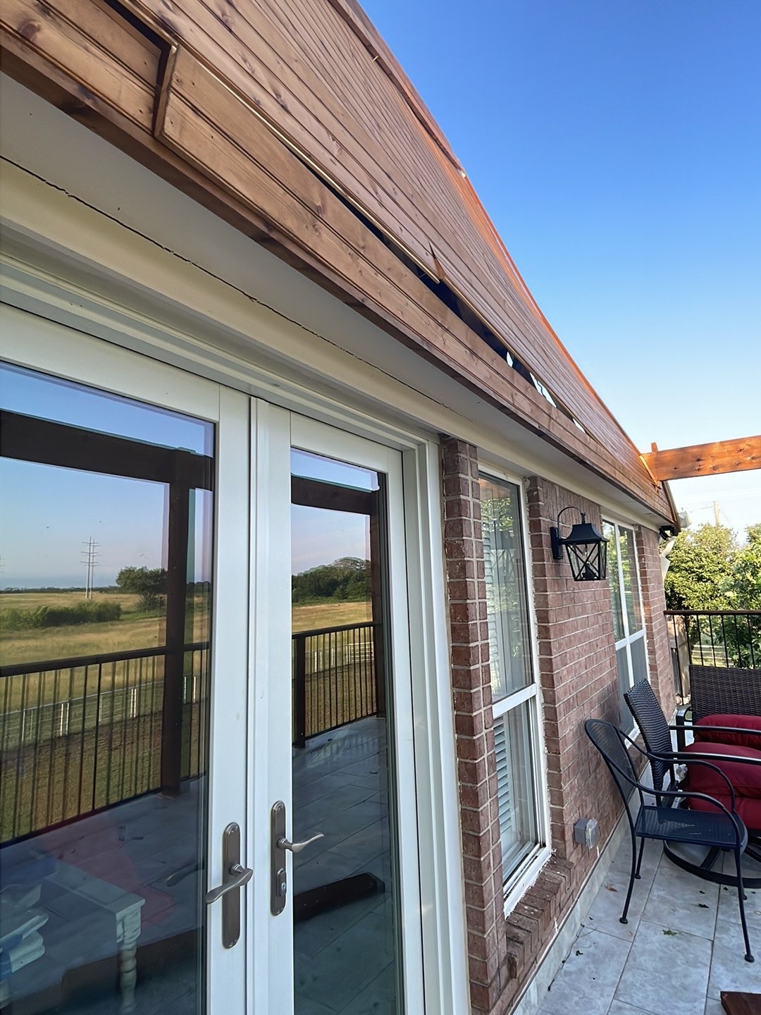 Home exterior and eave — McKinney TX Brick home exterior with patio doors and eave area inspected for water intrusion in McKinney, TX