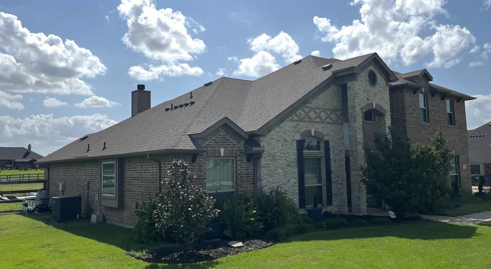 North Texas home with a newly replaced asphalt-shingle roof, gutters and fence