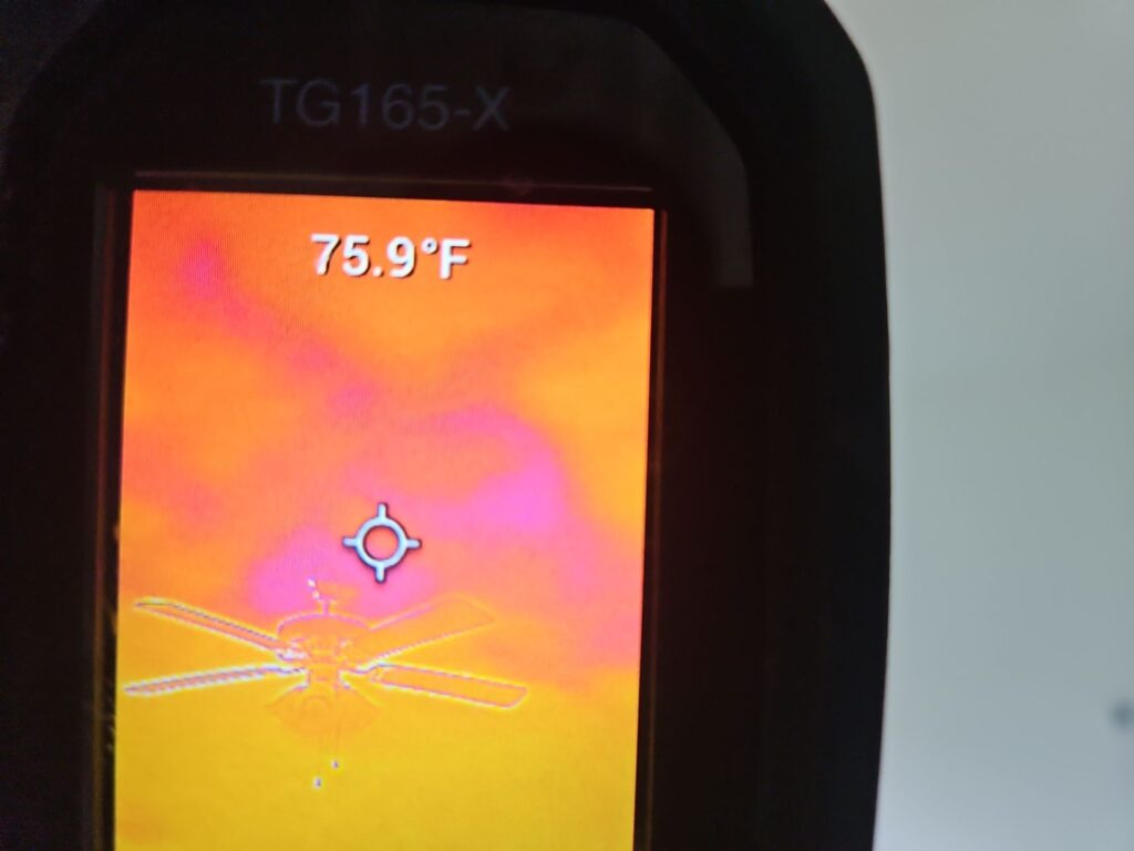 Thermal imaging device displaying a temperature reading during interior water mitigation inspection in Princeton, TX