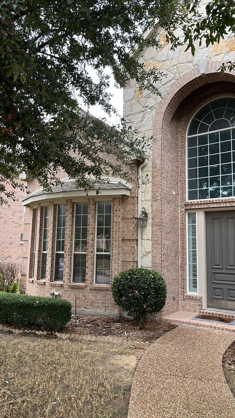 Allen TX home — roof and restoration Front exterior of a brick home in Allen, TX during a roofing and restoration project