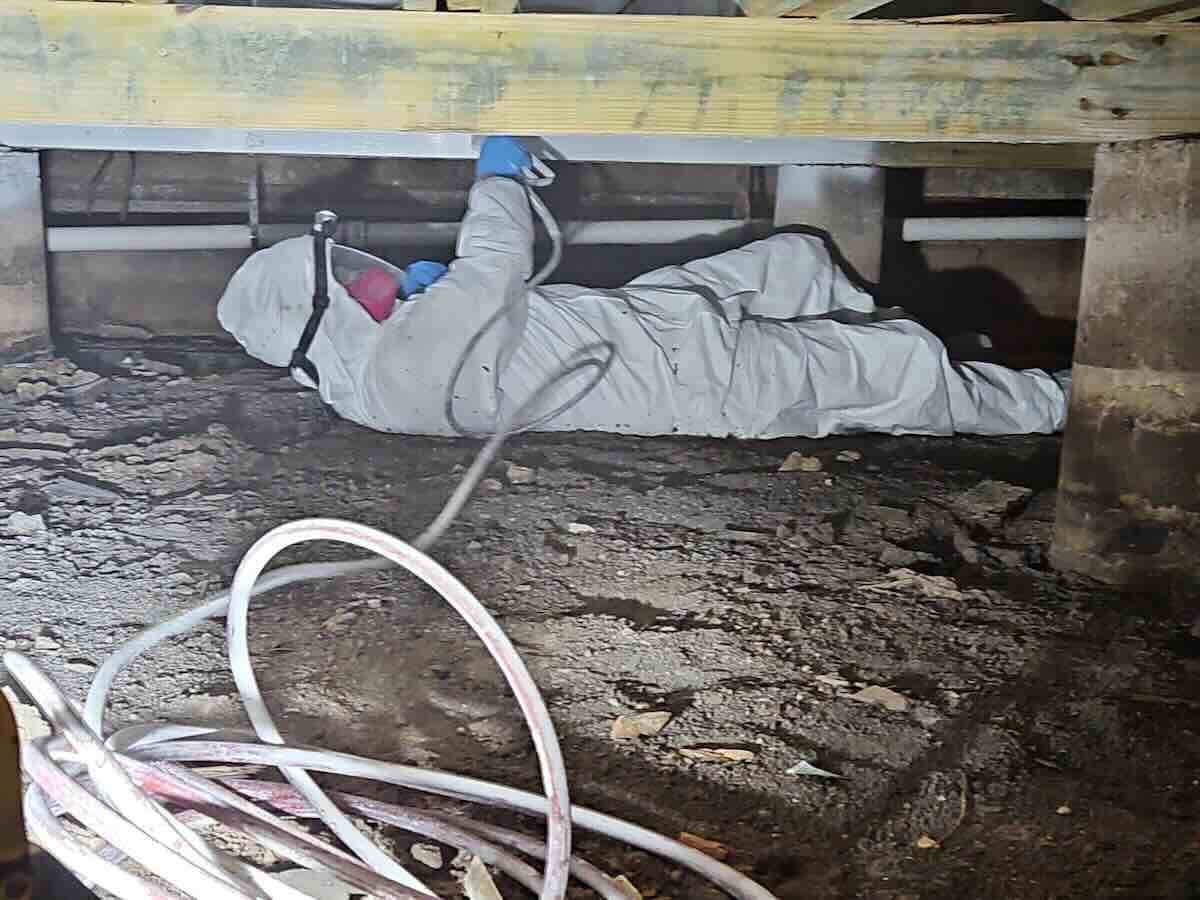 technician-working-in-crawlspace Rainy Day team at work or company culture
