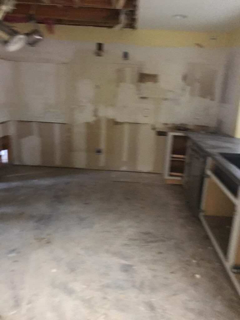 Kitchen with lower cabinets removed for water-damage reconstruction in Carrollton, TX