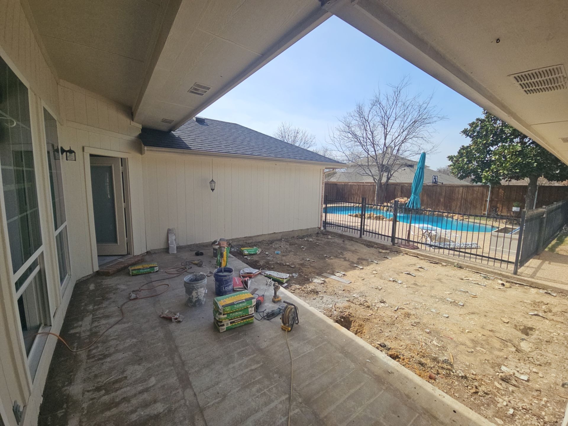 Bare sun-exposed backyard patio in Murphy before patio construction begins