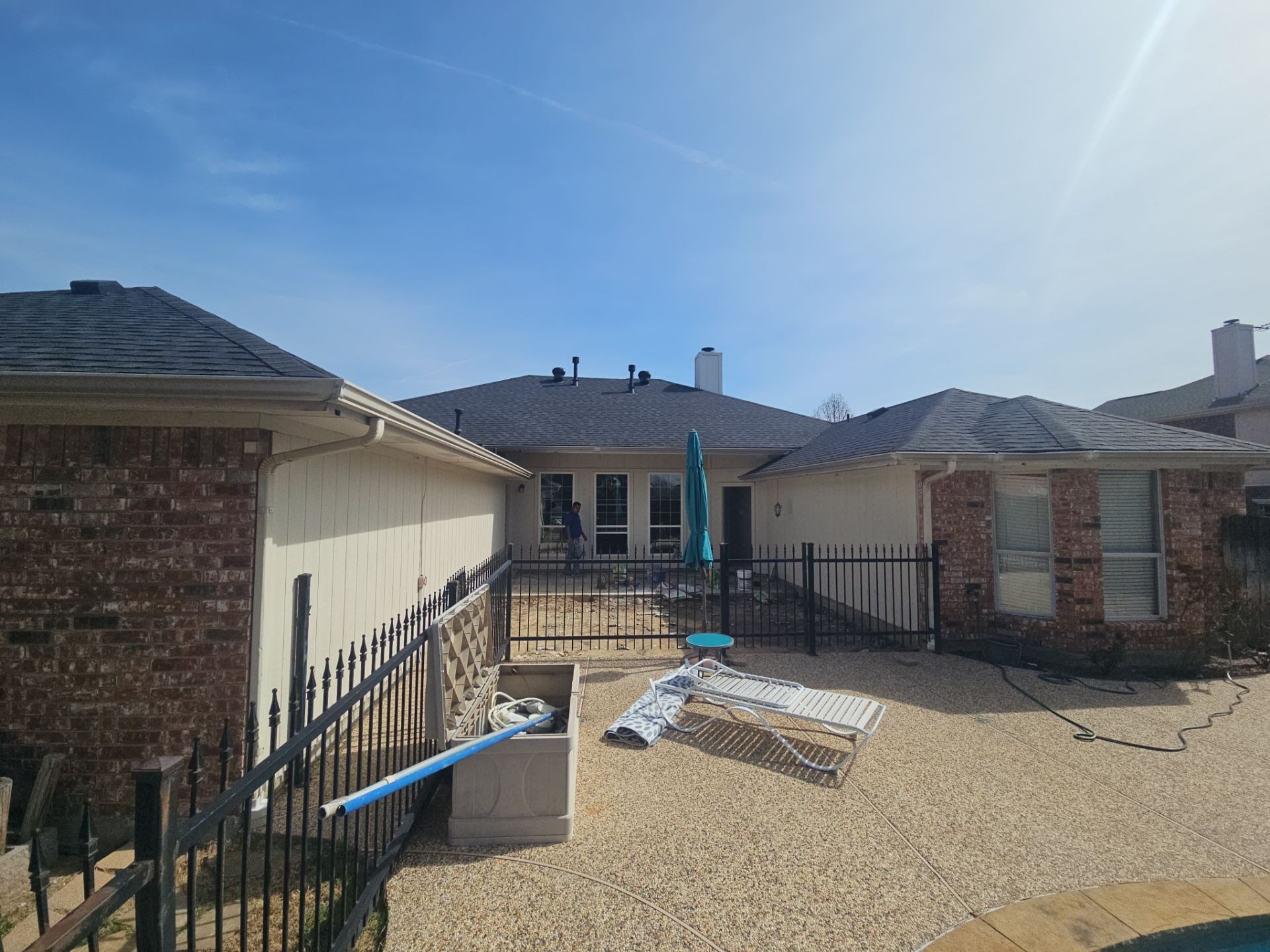 Wide view of the Murphy backyard before patio construction begins on the covered patio
