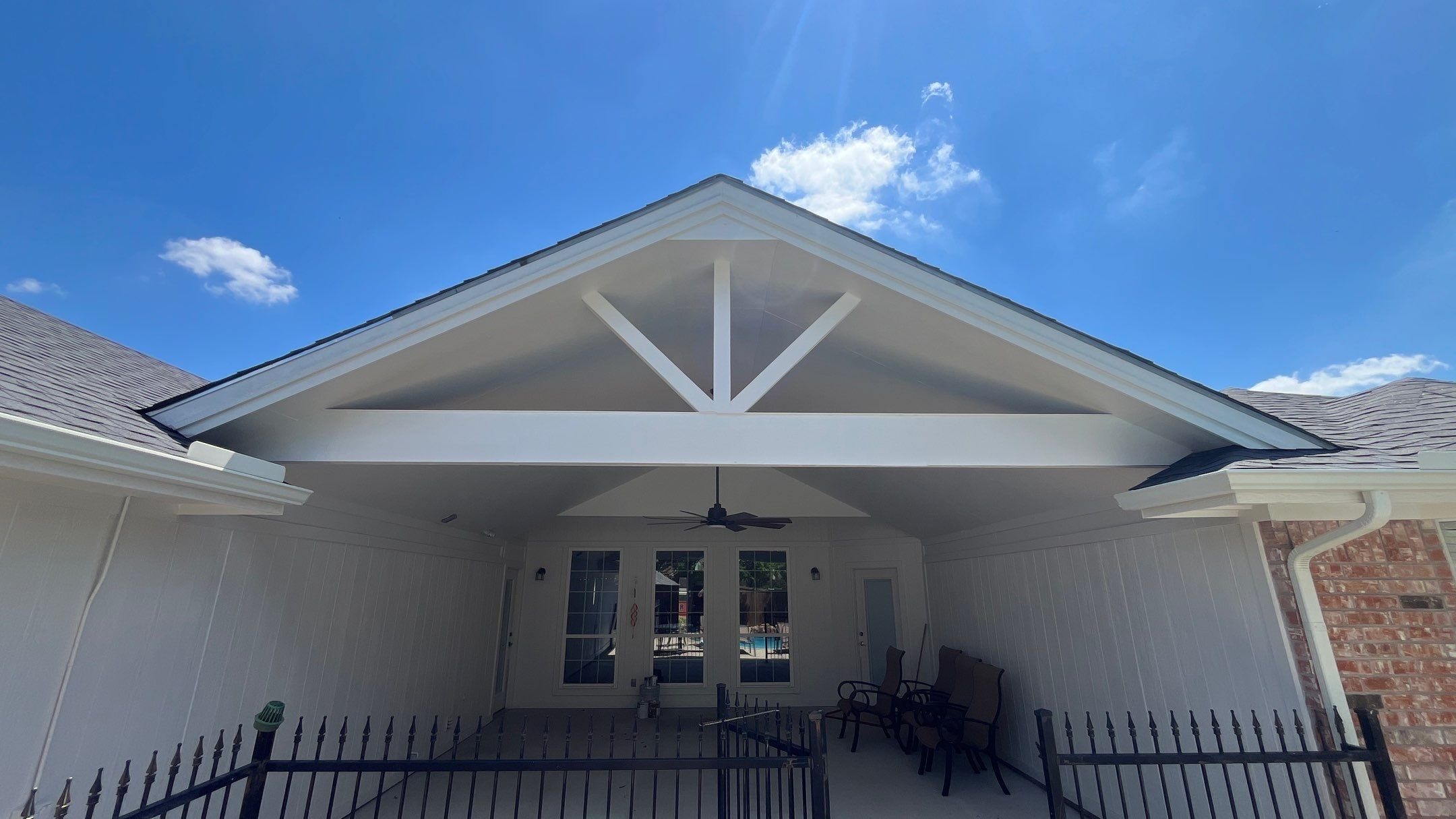 After patio construction in Murphy, completed concrete patio deck connects house to pool