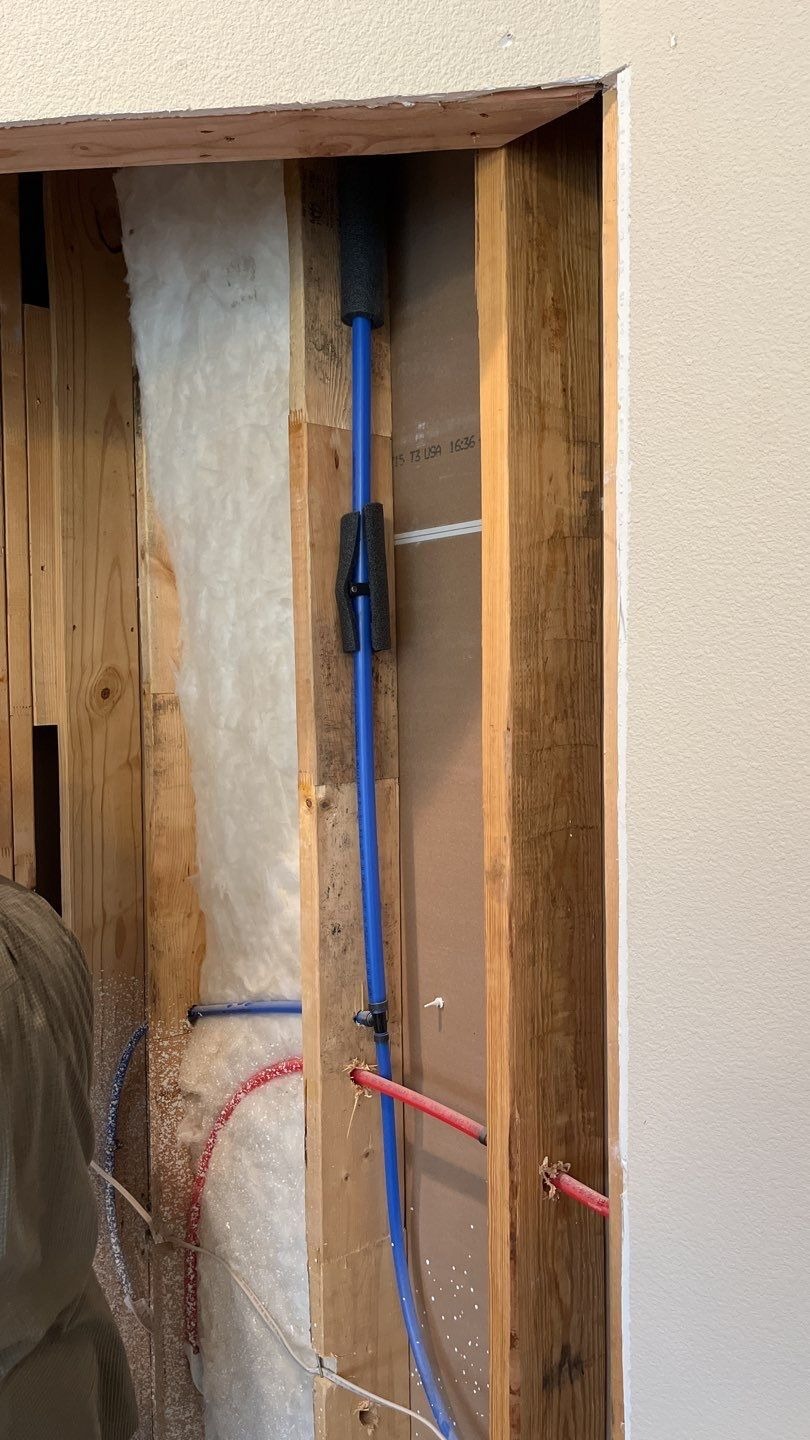 Wall opened up showing wiring reconfiguration during the fireplace remodel in Melissa, TX