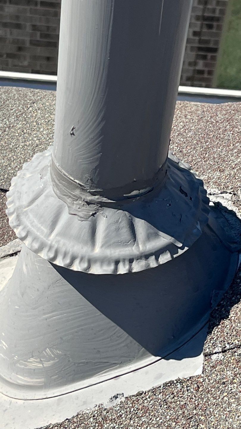 Soil erosion near a downspout base observed during the roof inspection in Prosper, TX