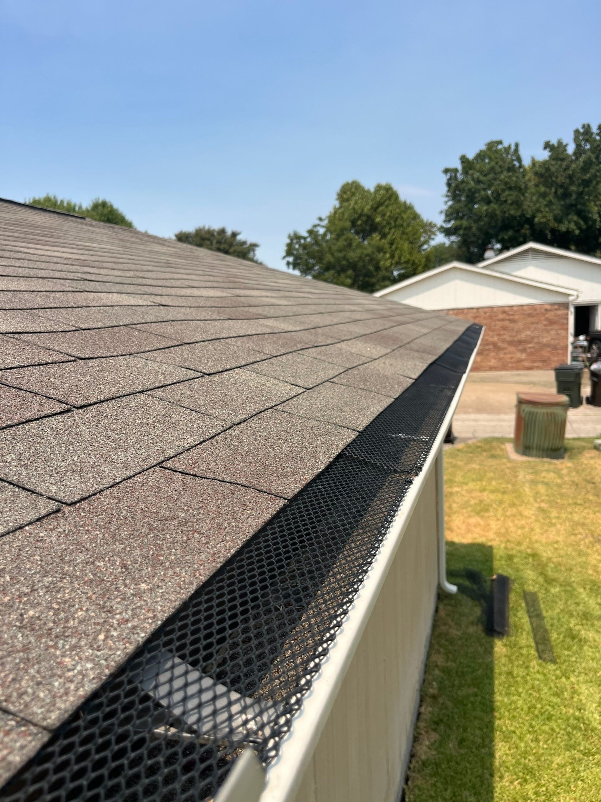 After gutter cleaning in Plano, new leaf screens line the freshly cleared gutters
