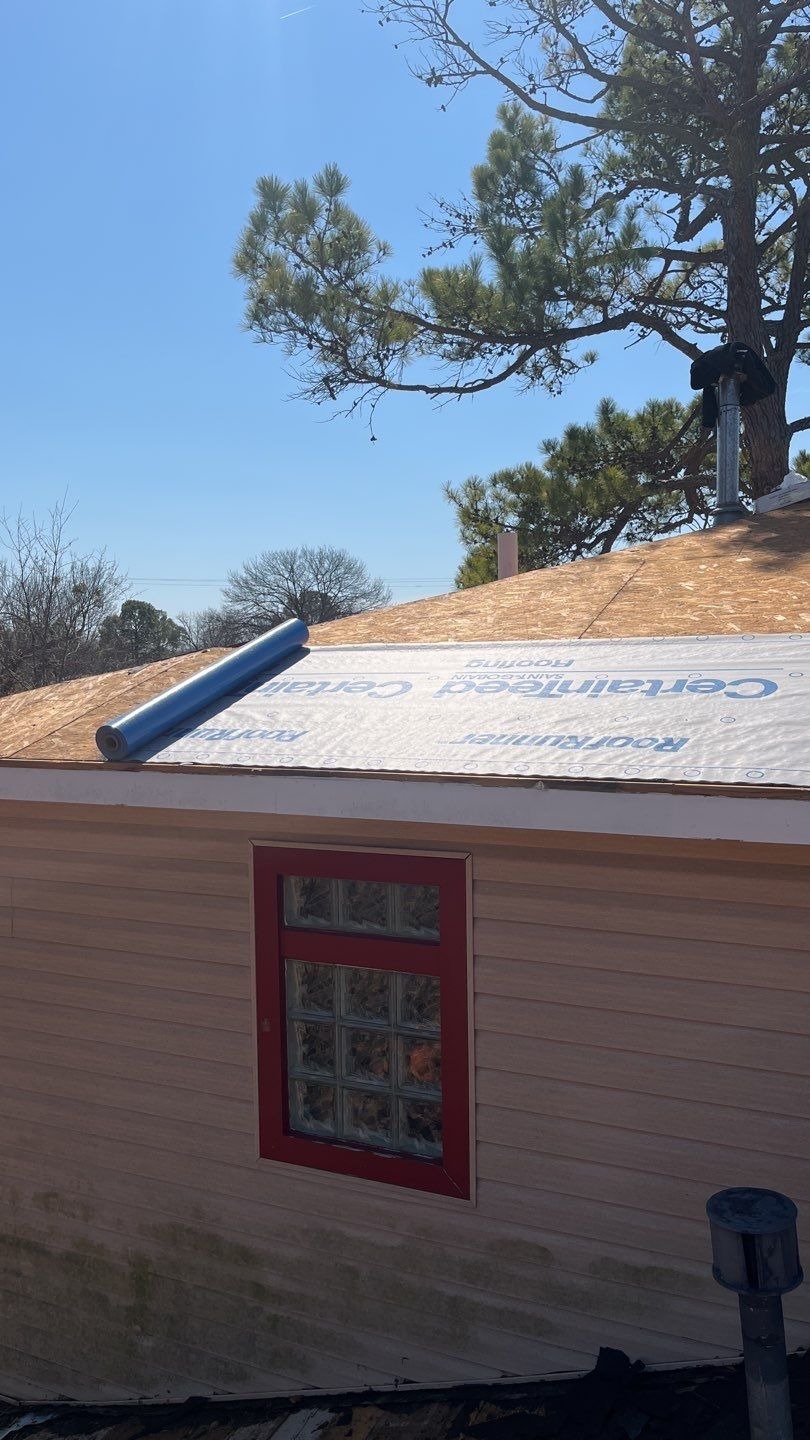 Multiple layers of old felt paper pulled up during the roof replacement in Sherman, TX