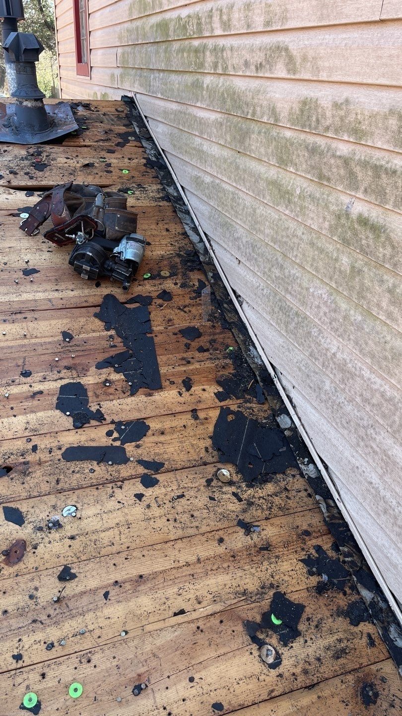 Crew inspecting decking condition during the roof replacement in Sherman, TX
