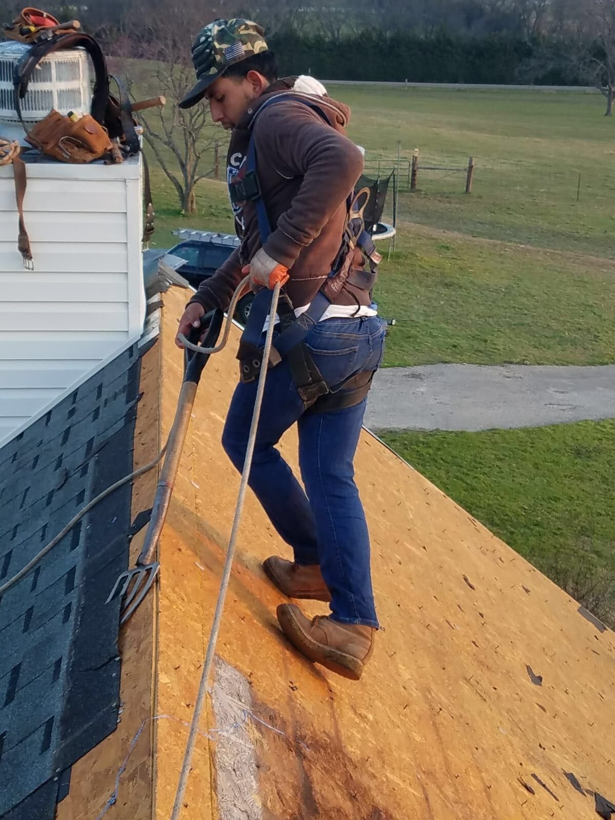 During roof replacement in Anna: crew tears off old shingles down to the roof deck