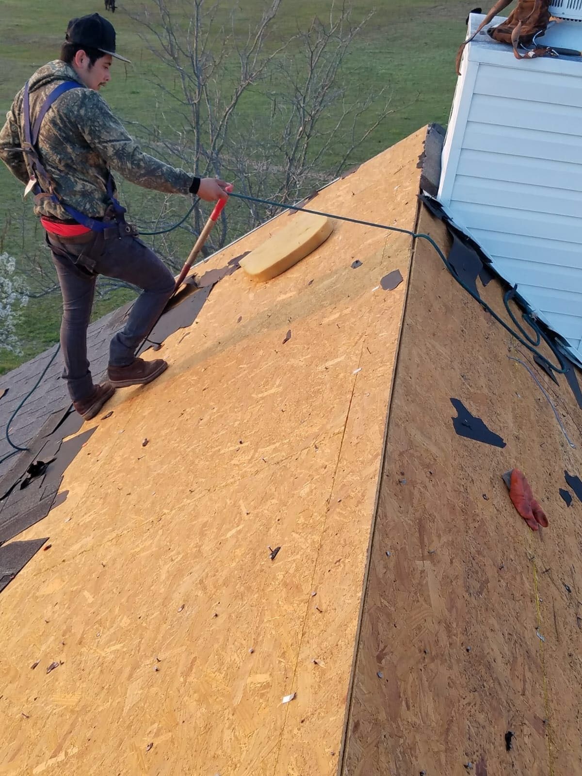 During roof replacement in Anna: synthetic underlayment installed across the farmhouse roof deck