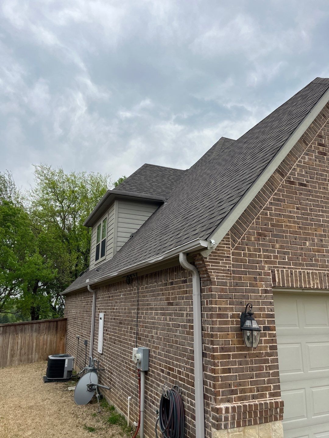 Finished shingle roofline after the completed roof replacement in Sherman, TX
