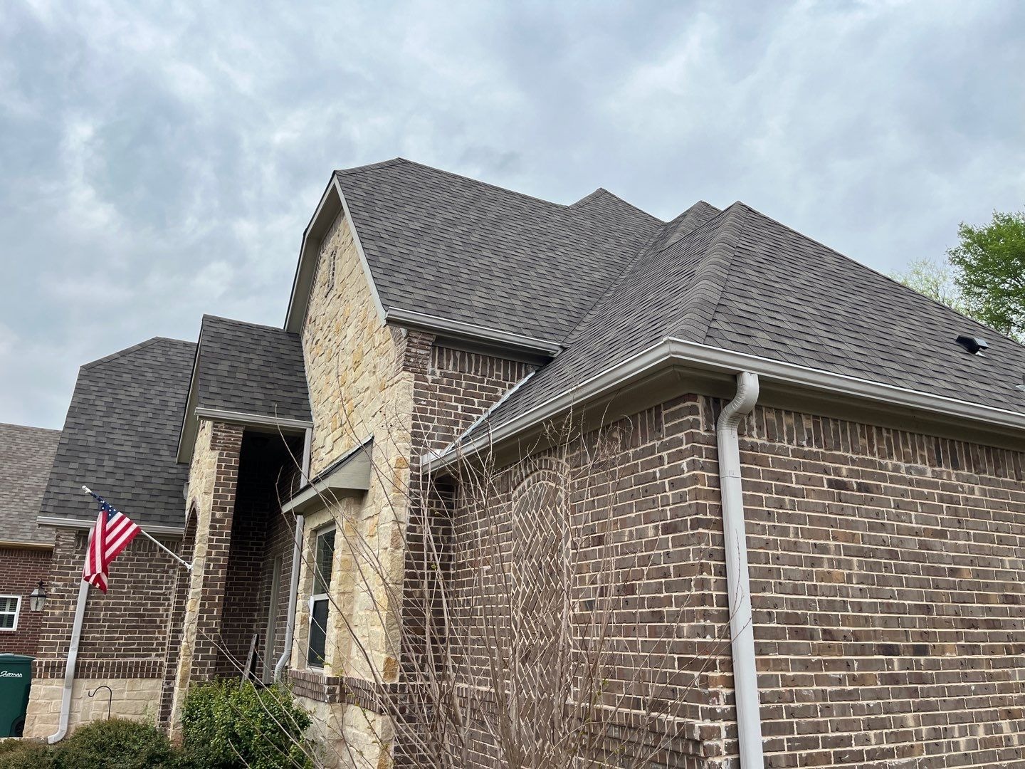 New aluminum gutters installed after the roof replacement in Sherman, TX