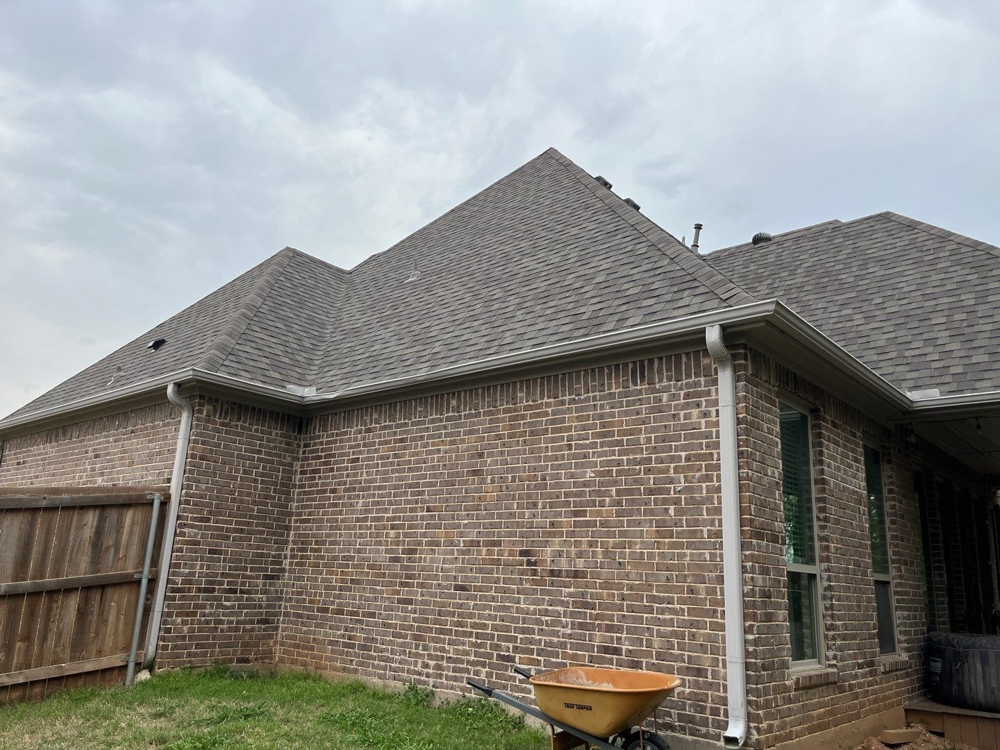 Completed roof from the ground after the roof replacement in Sherman, TX