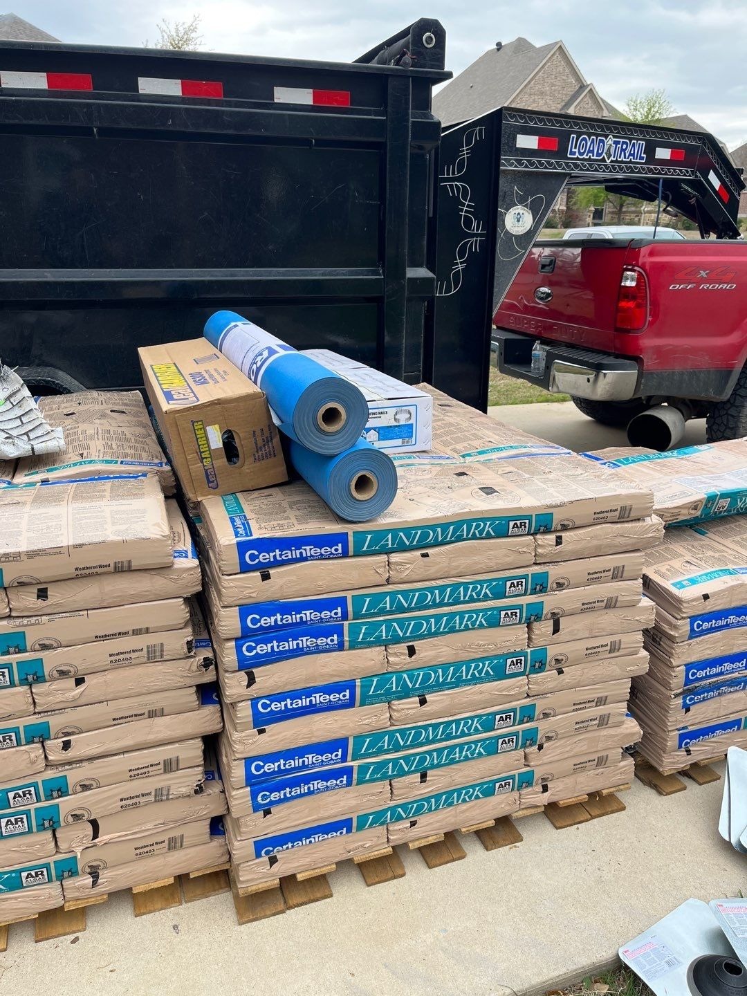 Synthetic underlayment being installed during the roof replacement in Sherman, TX