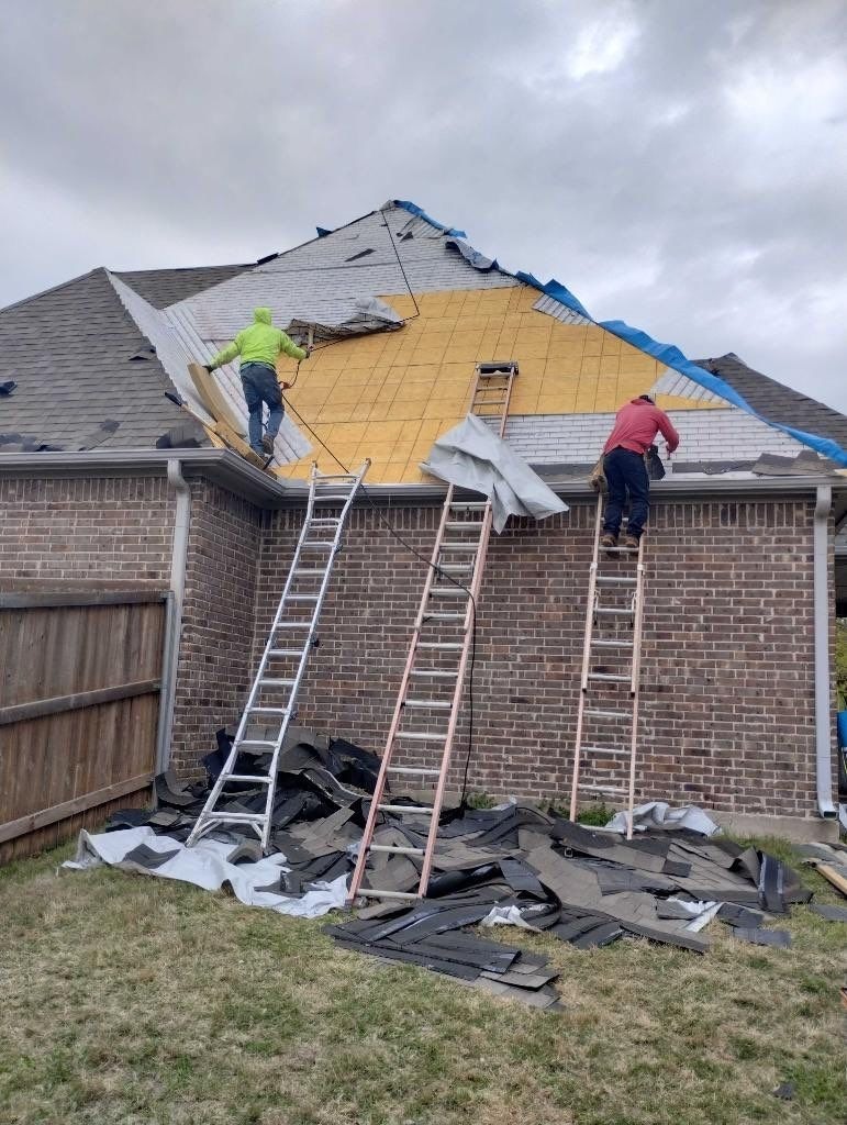 Shingle installation progressing across the roof during the roof replacement in Sherman, TX
