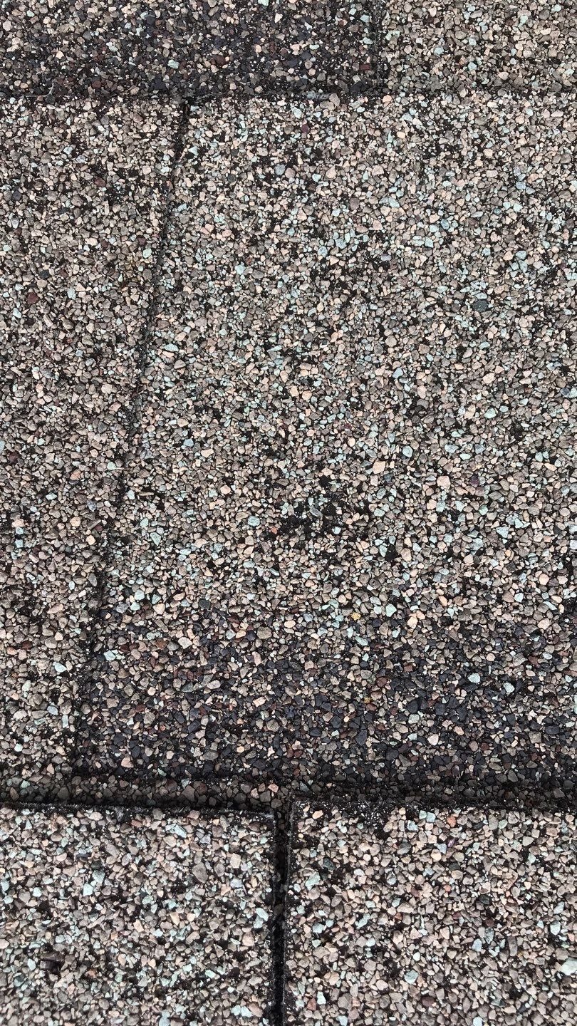 Wind-lifted shingle edge documented before the roof replacement in Melissa, TX