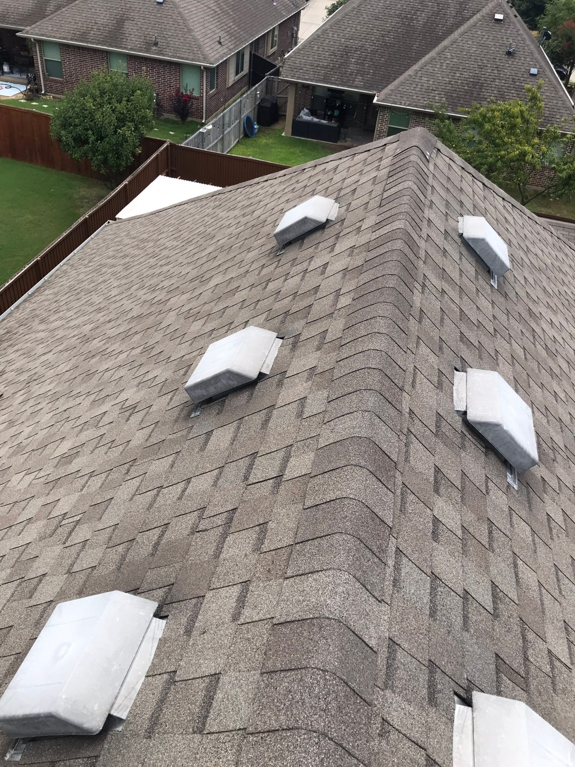 Close-up of hail bruising on shingle granules before the roof replacement in Melissa, TX