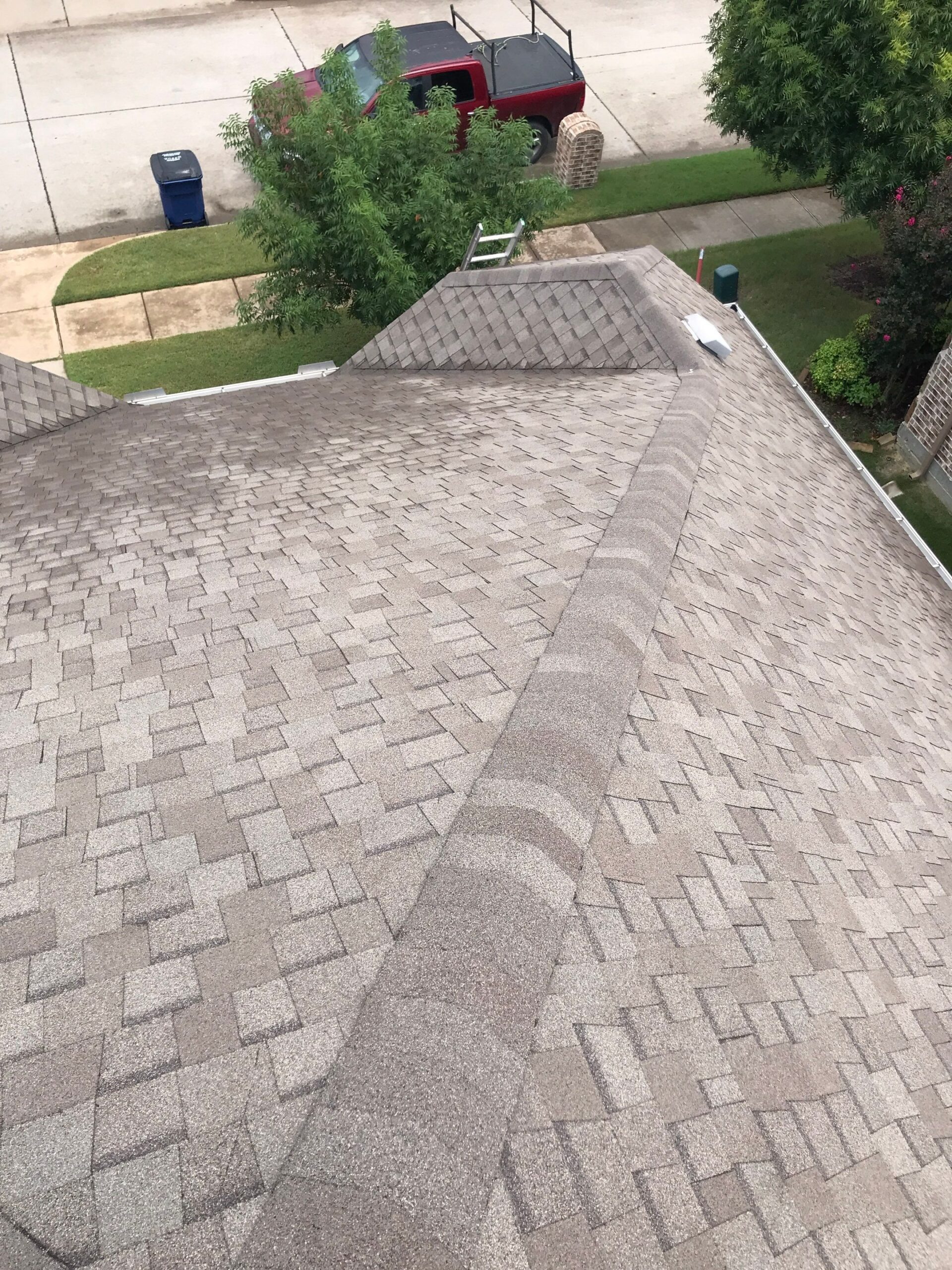 Wide view of storm damage across the roofline before the roof replacement in Melissa, TX