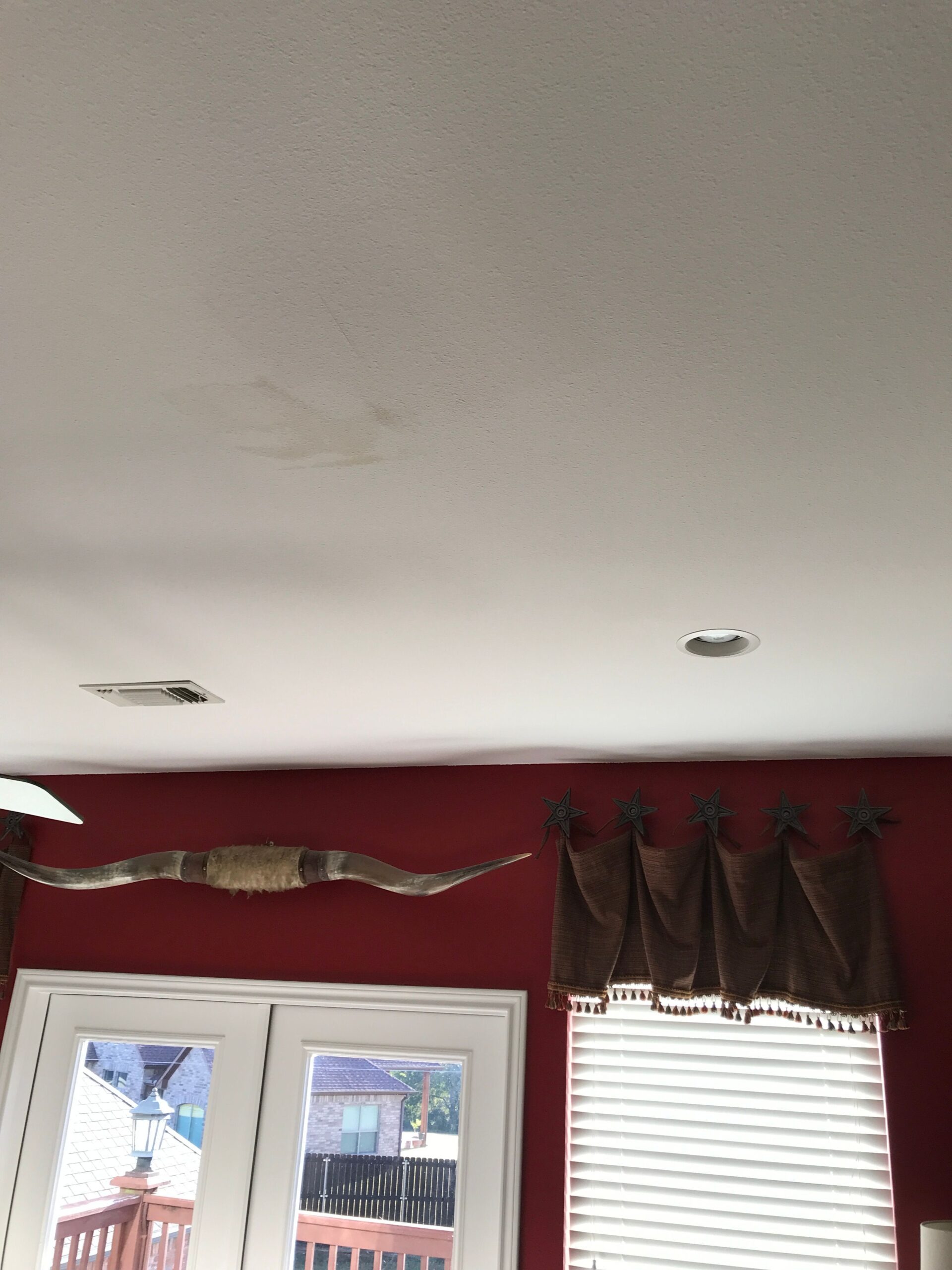 Cracked and bruised shingles showing hail impact before roof replacement work in Sherman