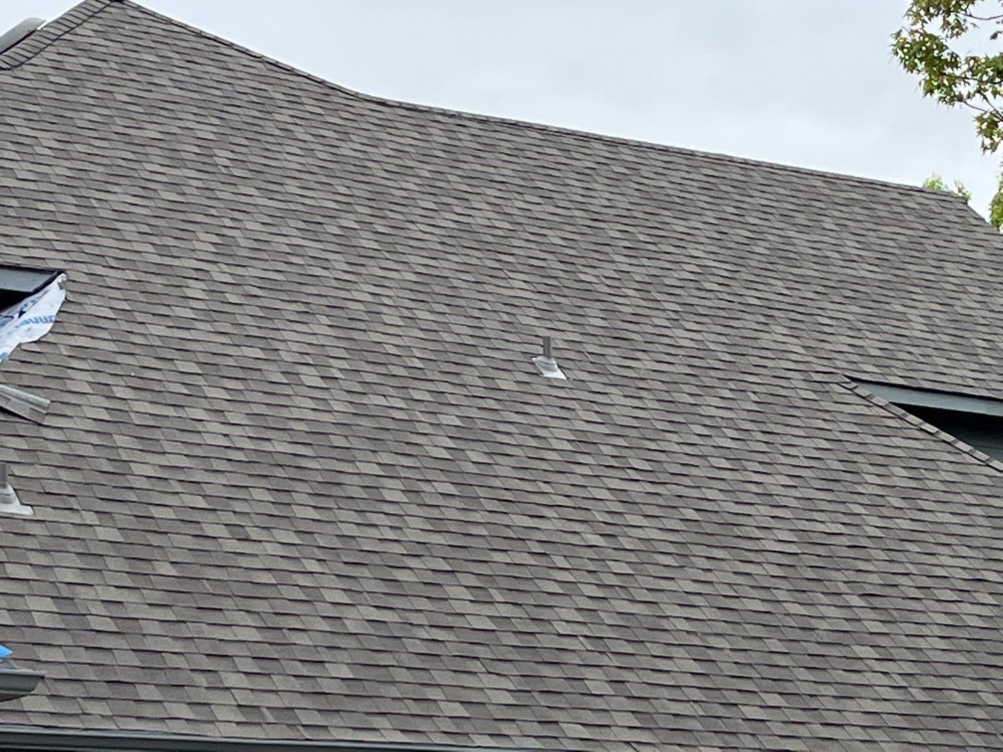 New custom chimney cap installed after the roof replacement in Sherman, TX