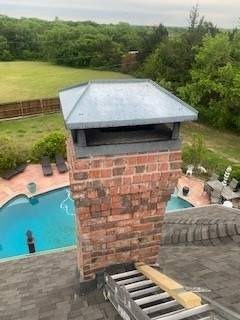Hail damage visible on a secondary roof section before replacement in Sherman