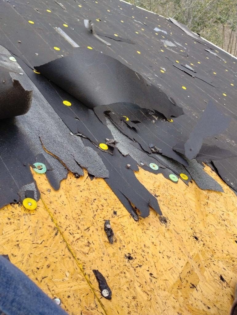 Synthetic underlayment installation underway during the roof replacement in Sherman, TX