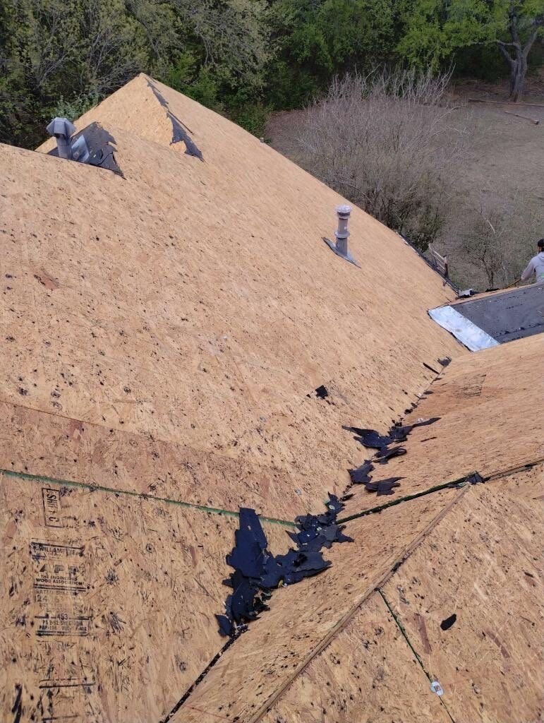 Crew installing new shingles during the roof replacement in Sherman, TX