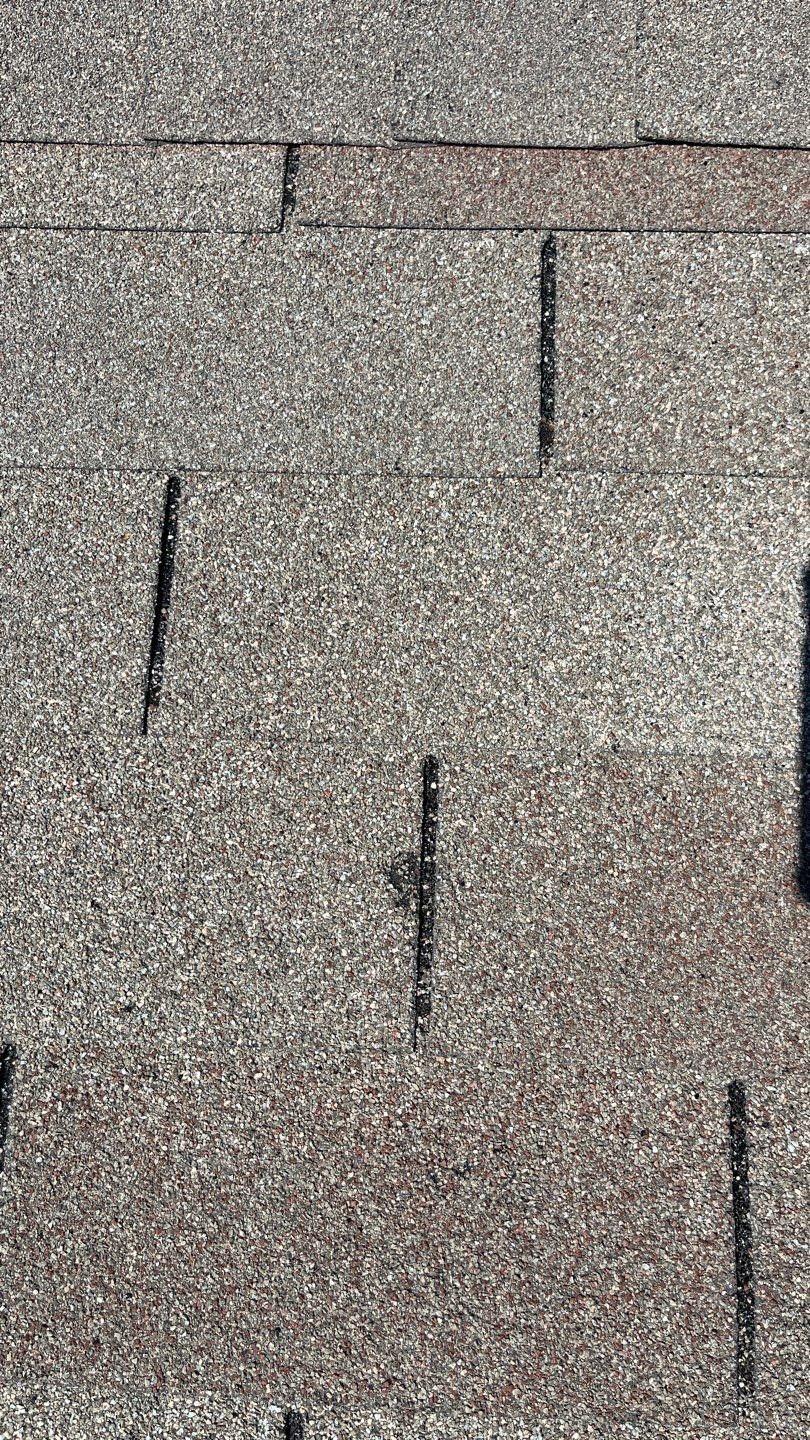 Before: wide view of storm-damaged shingles on Anna, TX roof awaiting replacement