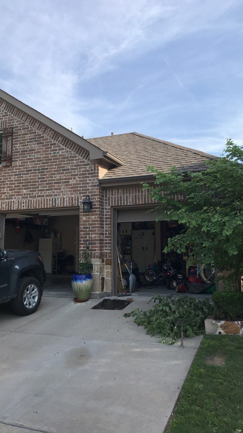 Hail bruising visible on shingles before the roof replacement in Melissa, TX