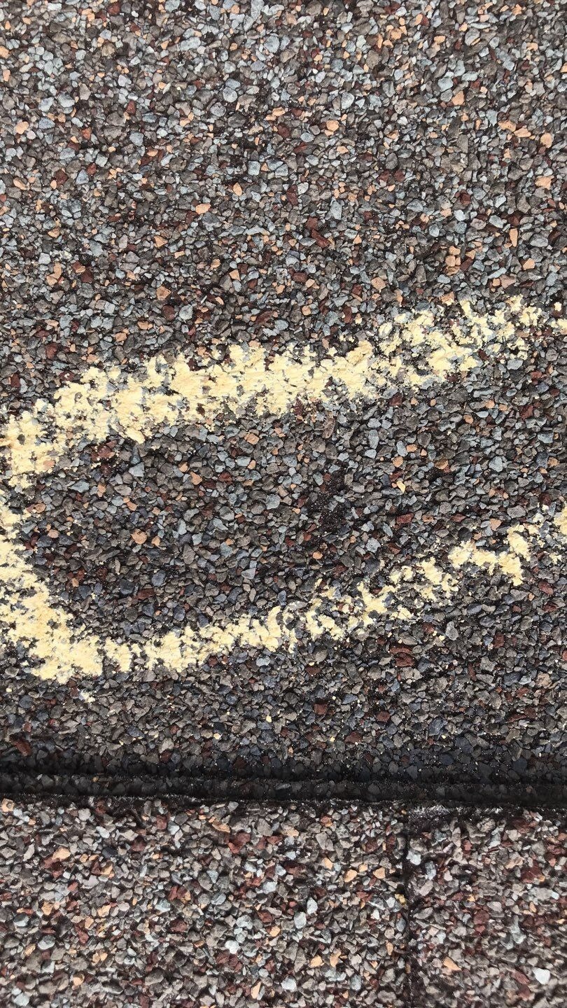 Storm-damaged shingle tabs before the roof replacement in Melissa, TX