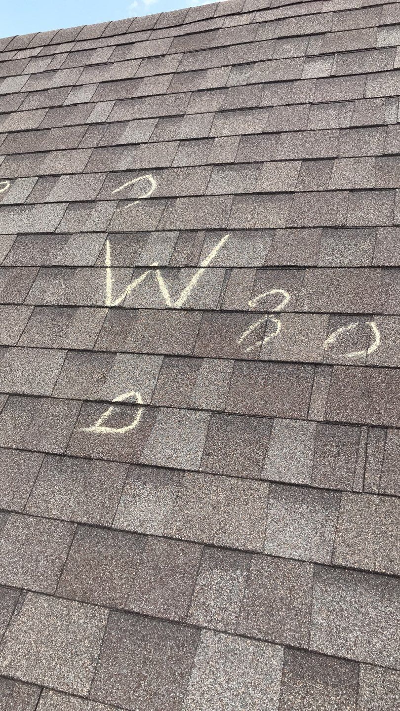 Garage door hail damage noted before the roof replacement in Melissa, TX