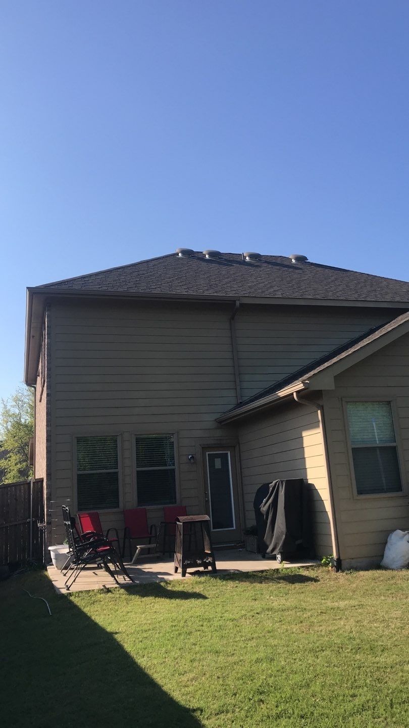 Before roof replacement in Anna: hail-damaged shingles and gutters show scattered impact marks