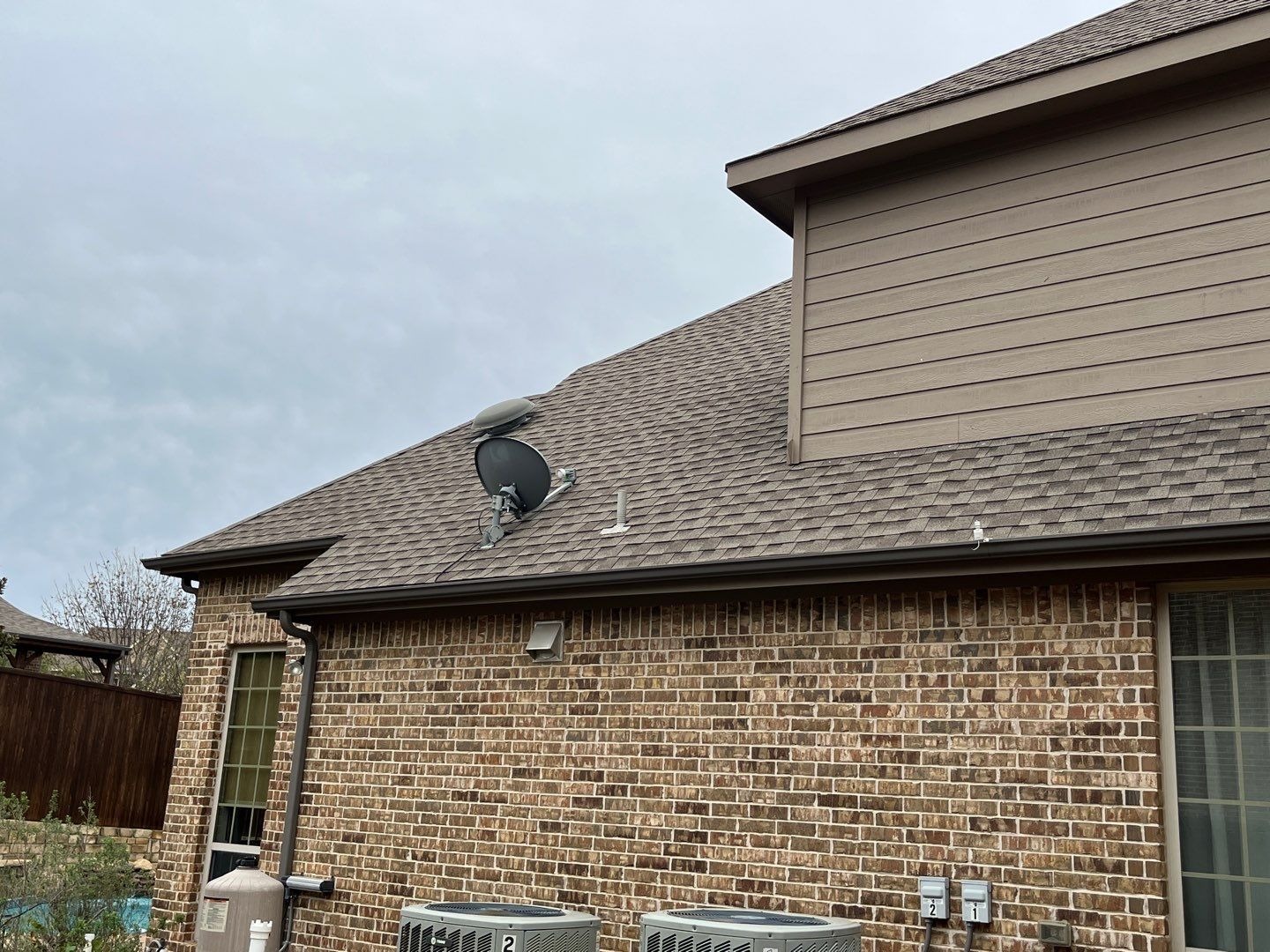 Storm-damaged gutter section documented before the roof replacement in Prosper, TX