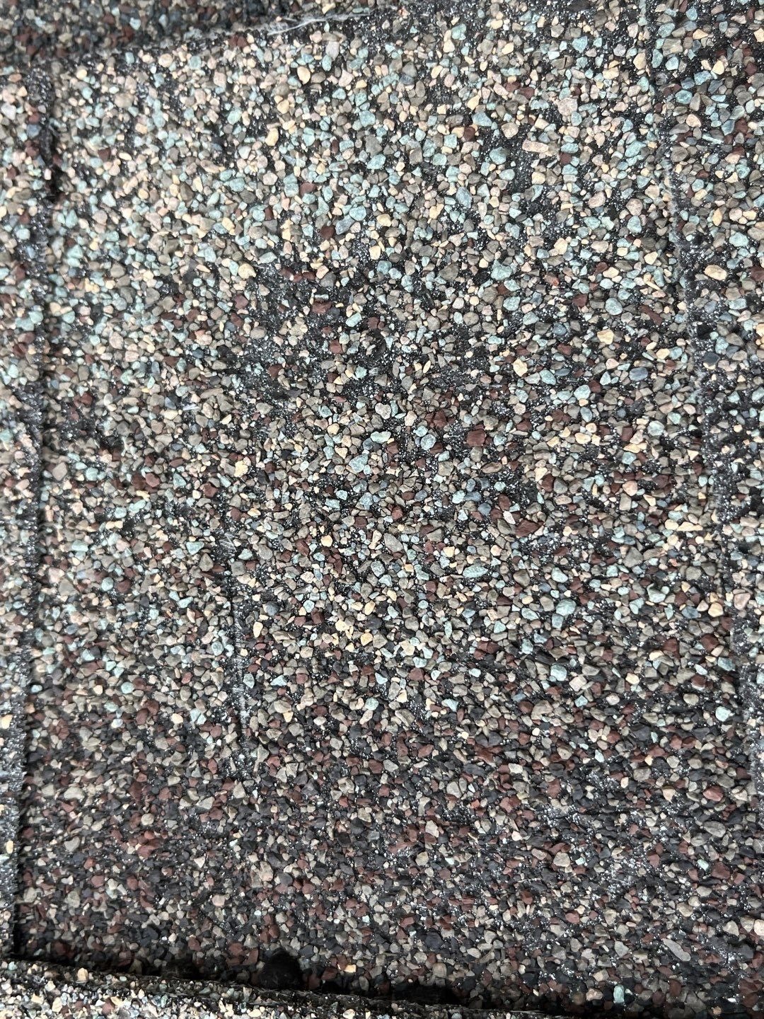 Cracked shingle mat exposed during inspection ahead of the roof replacement in Prosper, TX
