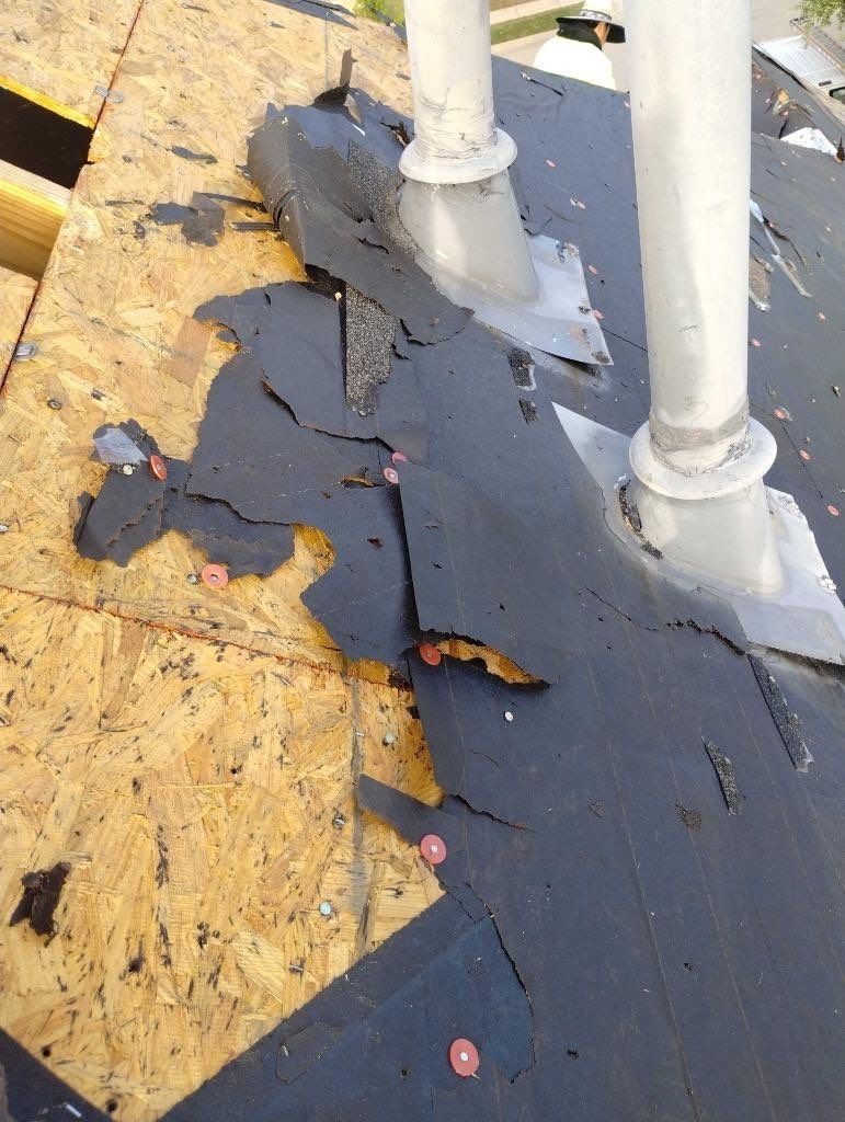 Roof deck and new underlayment visible during the roof replacement in Prosper, TX