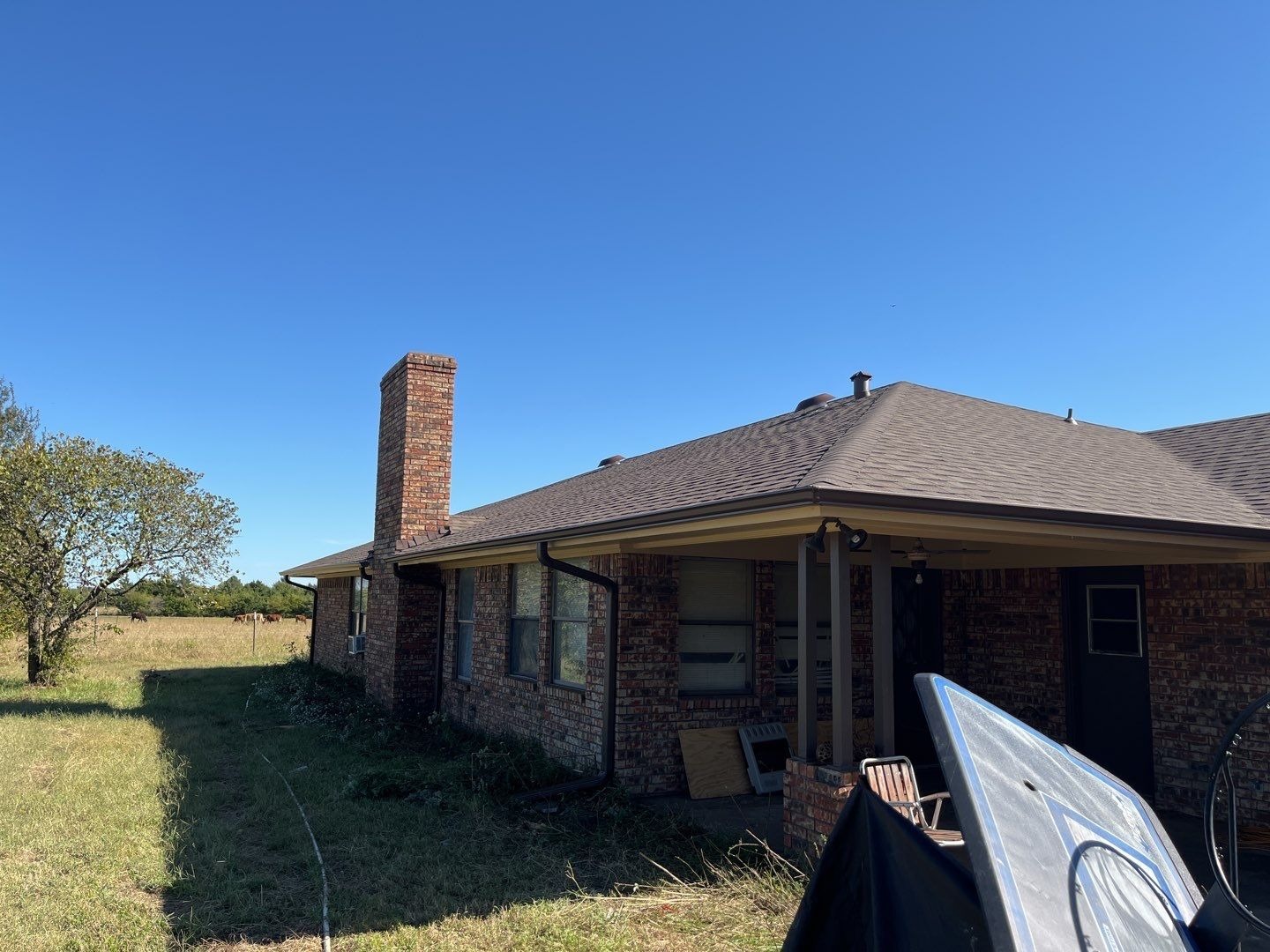 New seamless aluminum gutters and downspouts after the roof replacement in Sherman, TX