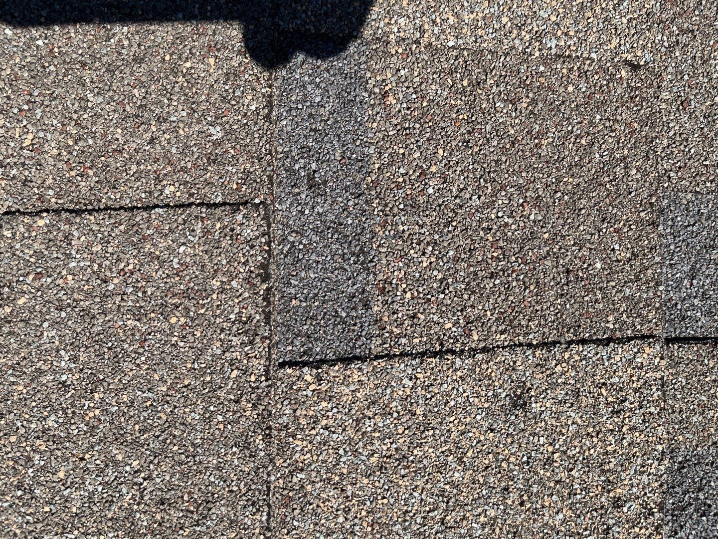 Granule loss on damaged shingles documented before this Melissa roof replacement