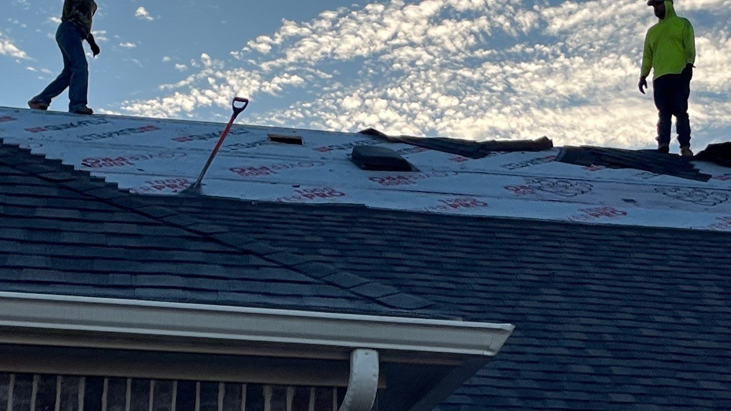 During roof replacement in Anna: crew installing new CertainTeed Landmark shingles in Weather Wood