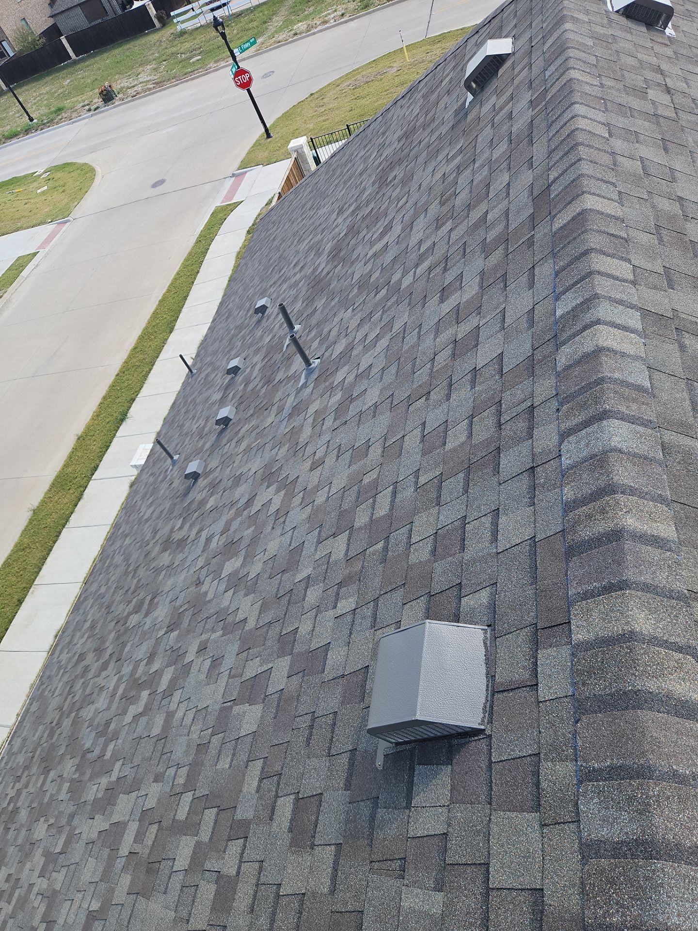 After roof replacement in Anna: completed shingle field with new flashing and vents in place